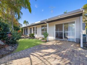 a house with a patio and a yard at Maroochy 4 Bedroom Family Beachhouse in Maroochydore