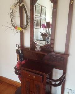 a wooden dresser with a mirror on top of it at Ely House B&B in Shannonbridge +50 photos