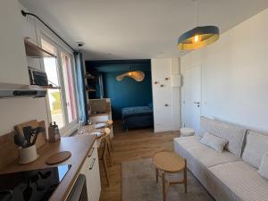 a living room with a couch and a table at Maison Gabanne in Le Croisic