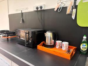 a kitchen counter with a coffee maker and a blender at Eco Nature Mulia Private villa in Harumalgoda West