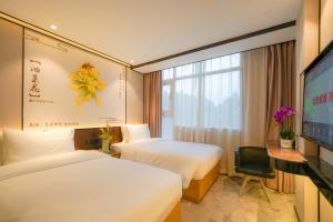 Postel nebo postele na pokoji v ubytování Guangdong Baiyun City Hotel + 37 fotografií