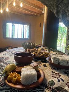 a table topped with plates of food on a table at The Cave in Yatiyantota