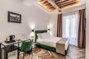 a hotel room with a bed and a desk at Effe Luxury Rooms in Rome