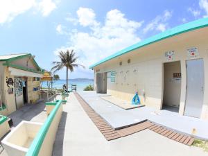 a building with the ocean in the background at Tokashiku Marine Villege in Tokashiki