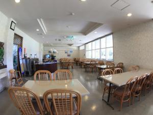 a dining room with tables and chairs in a restaurant at Tokashiku Marine Villege in Tokashiki