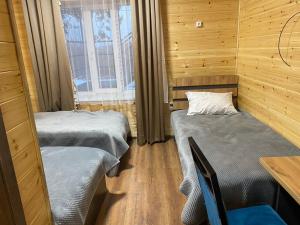 a room with two beds and a table and chairs at Syi-Ordo in Pokrovka