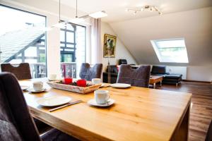 a dining room with a wooden table and chairs at FeWo Siebenstern in Winterberg