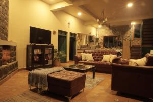a living room with a couch and a table at Fifth Estate in Vagamon