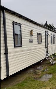a white trailer with windows on the side of it at Karen's Caravan in Great Yarmouth