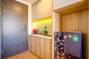 a kitchen with a refrigerator and a counter at Best Deal and Comfort Studio Citra Living Apartment By Travelio in Jakarta