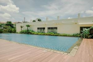 a swimming pool in front of a house at Best Deal and Comfort Studio Citra Living Apartment By Travelio in Jakarta