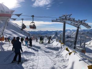 a group of people skiing on a ski lift at Ferienhaus Herrenschmiede in Obervellach
