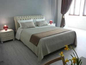 a bedroom with a large bed with a white bedspread at Brilliant Camere in Trieste