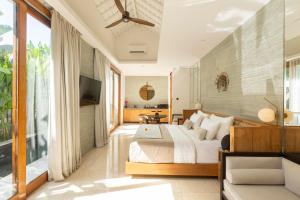 a bedroom with a bed and a television in it at Astera Villa Seminyak by Ini Vie Hospitality in Seminyak +32 photos