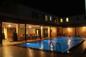 a large swimming pool in a building at night at Earl's Red Passikudah in Pasikuda