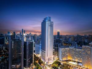 a tall building in a city at night at Gwen Jane Hotel Free shuttle buses at the exhibition hall during the Canton Fair in Guangzhou