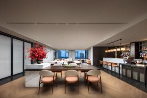 a kitchen and dining room with a table and chairs at Gwen Jane Hotel Free shuttle buses at the exhibition hall during the Canton Fair in Guangzhou