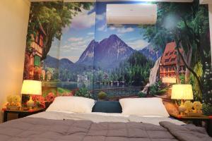 a bedroom with a large mountain mural on the wall at Luxury Manzil in Lahore