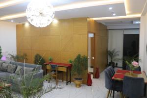 a living room with a couch and a table at Luxury Manzil in Lahore
