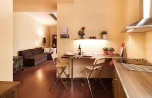 a kitchen and living room with a table and chairs at BmyGuest - Santa Catarina Light Apartment in Porto