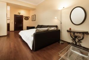 a bedroom with a bed and a large mirror at BmyGuest - Santa Catarina Light Apartment in Porto