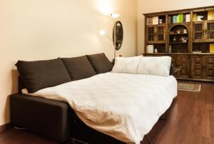 a bed in a living room with at BmyGuest - Santa Catarina Light Apartment in Porto