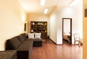 a living room with a couch and a bedroom at BmyGuest - Santa Catarina Light Apartment in Porto