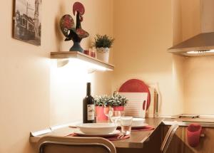 a kitchen with a table with a bottle of wine at BmyGuest - Santa Catarina Light Apartment in Porto