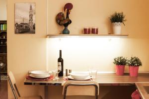 a dining room with a table with a bottle of wine at BmyGuest - Santa Catarina Light Apartment in Porto