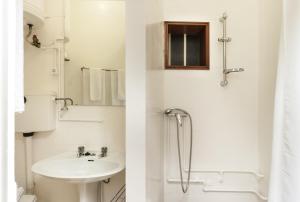 a white bathroom with a sink and a shower at BmyGuest - Santa Catarina Light Apartment in Porto