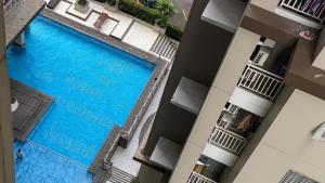 an overhead view of a swimming pool in a building at Spacious 2BR at Pakubuwono Terrace Apartment By Travelio in Jakarta