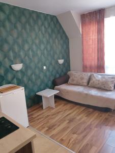 a bedroom with a bed and a green wall at Studio in Sea Breeze Complex Sveti Vlas in Sveti Vlas
