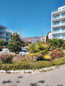 a park with plants in front of a building at Studio in Sea Breeze Complex Sveti Vlas in Sveti Vlas +15 photos