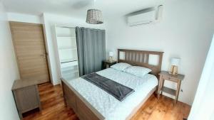 a bedroom with a bed and two night stands at Maison avec piscine entre Chartreuse et Vercors in La Buisse +8 photos