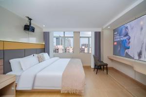 Postel nebo postele na pokoji v ubytování Shengmeiya Apartment Hotel-Line8 Pazhou STN entrance D-Walking distance to Canton Fair