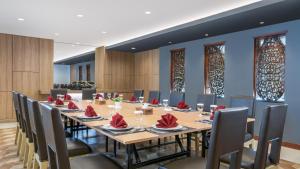 a large conference room with a long table and chairs at Swiss-Belhotel Manokwari in Manokwari +69 photos