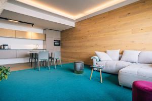 a living room with a couch and a kitchen at LAKESIDE Apartements in Zwenkau