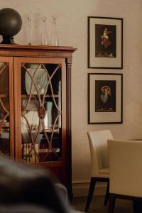a dining room with a china cabinet and two chairs at Hotel Bristol, A Luxury Collection Hotel, Warsaw in Warsaw
