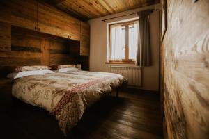 a bedroom with a bed and a window at Snowflake Appartamenti Jouvenceaux in Sauze dʼOulx
