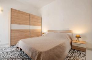 a bedroom with a large bed with a large headboard at Cozy Duplex Apartment by SF Homes in Rabat