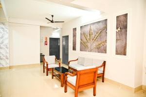 a dining room with chairs and a table at Hotel Royal Beltola in Guwahati