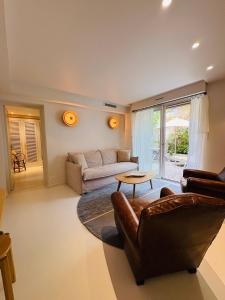 a living room with a couch and a table at Hotel des Dunes in Cap-Ferret