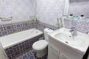 a bathroom with a white toilet and a sink at Iman Hotel in Bukhara +49 photos