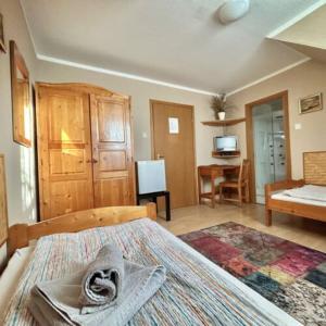 a bedroom with a bed and a desk in a room at Romantik Panzió in Bük +8 photos
