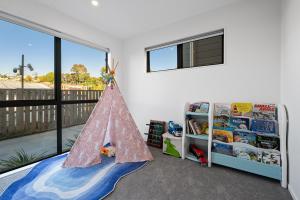 a childs room with a toy pyramid in the floor at Luxury 4 BR Retreat 4 bath with 3 Master Suites and Kids' Playroom in Auckland