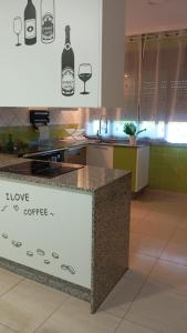 a kitchen with a counter with a sign that says hope coffee at A Eira de Salvador in Portas