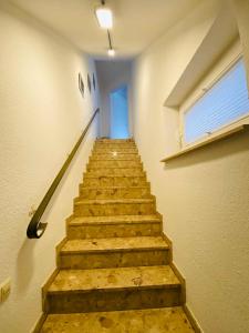 a stairway in a building with a stair case at Pension und Ferienwohnung Kristen Am Denkmal Süptitzer Höhen in Zietenhof