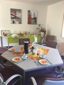 a table with plates of food on top of it at Pension und Ferienwohnung Kristen Am Denkmal Süptitzer Höhen in Zietenhof