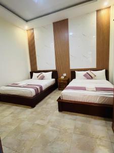 Voodi või voodid majutusasutuse Hoang Quan Hotel toas