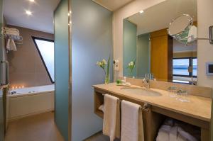 a bathroom with a sink and a mirror at NH Bariloche Edelweiss in San Carlos de Bariloche